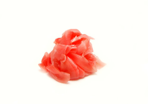 Pickled Pink Ginger Slices in Wooden Bowl on Bamboo Mat Next To Stock Photo - Im